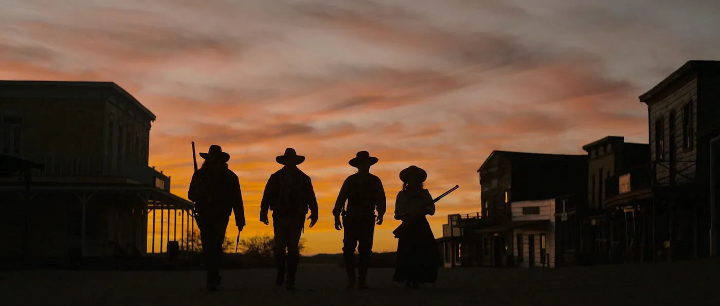 Cowboys on a sunset background