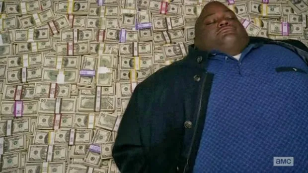 Huell from Breaking Bad sleeping on a pile of money