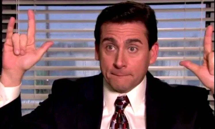 Michael Scott from The Office making a rock sign