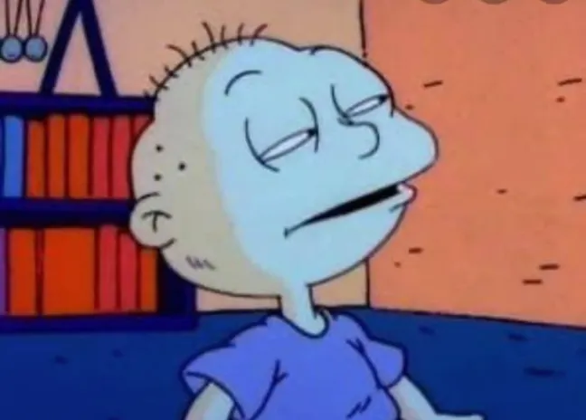 Tommy Pickles from Rugrats with a suspicious look
