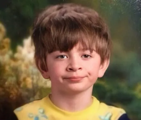 A boy with a tedious expression